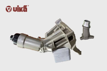 What are the components of the oil cooler assembly?