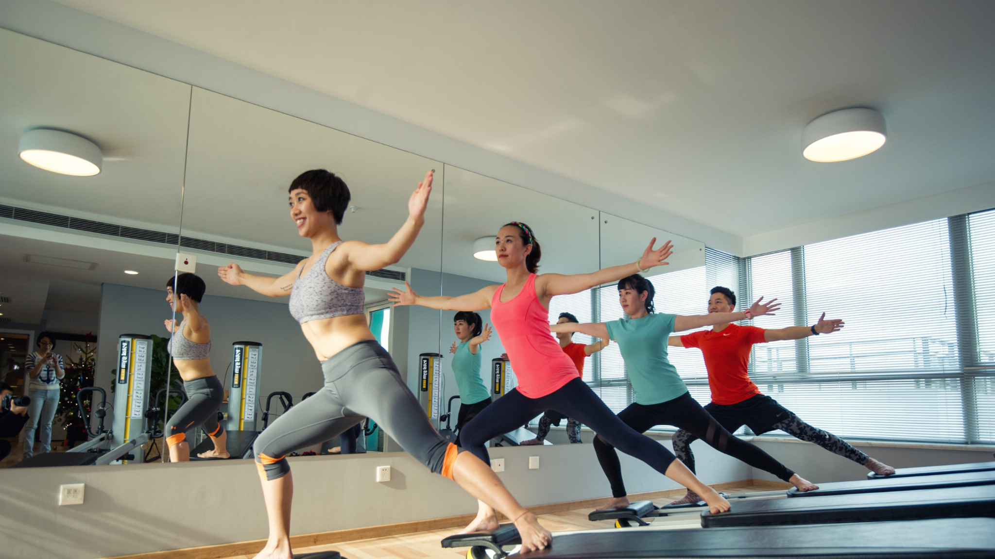 studio members doing reformer pilates class 