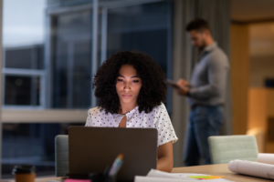 woman using laptop for gym marketing